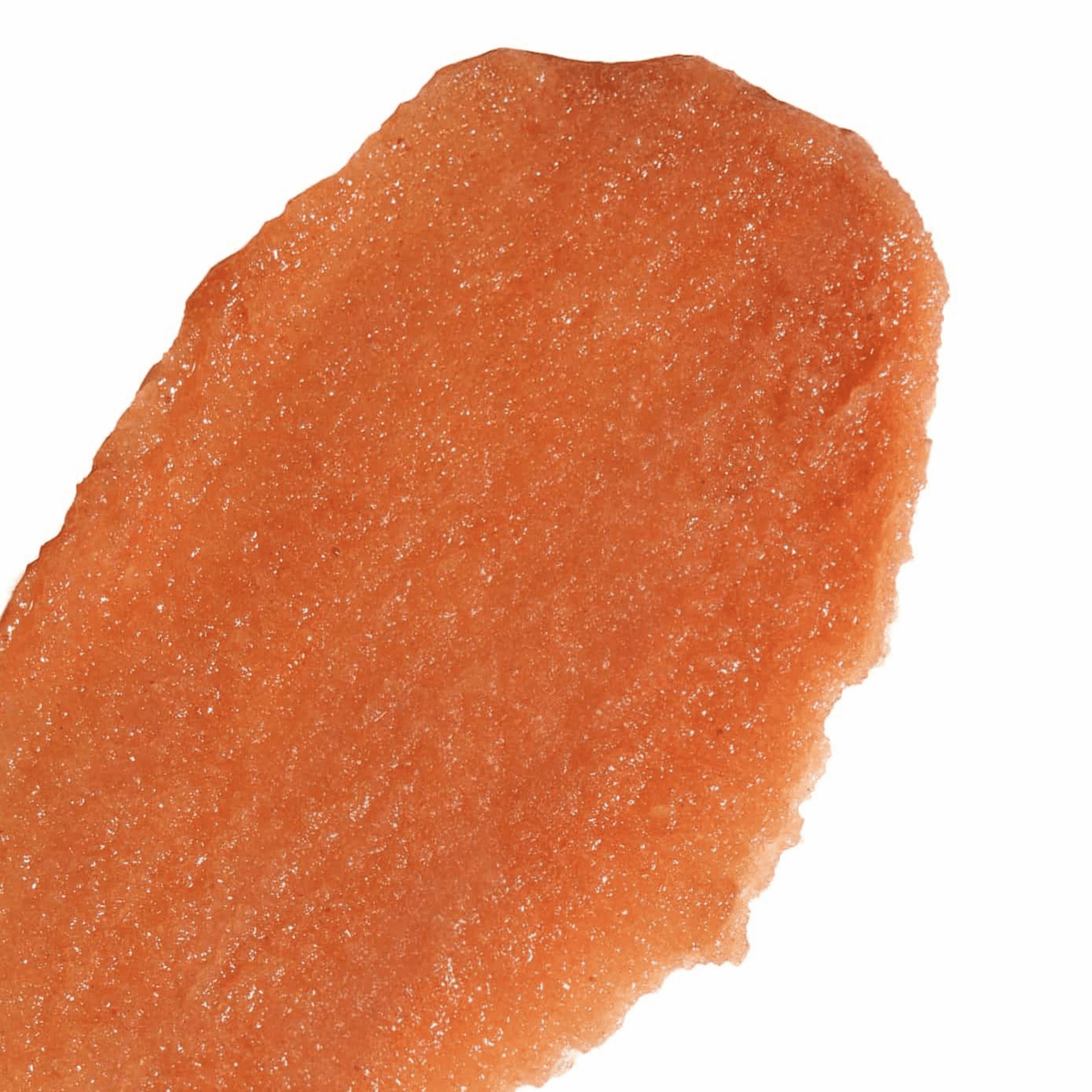 Close-up of Nopalera Flor de Madera Body Polish showcasing its orange, grainy texture against a white background