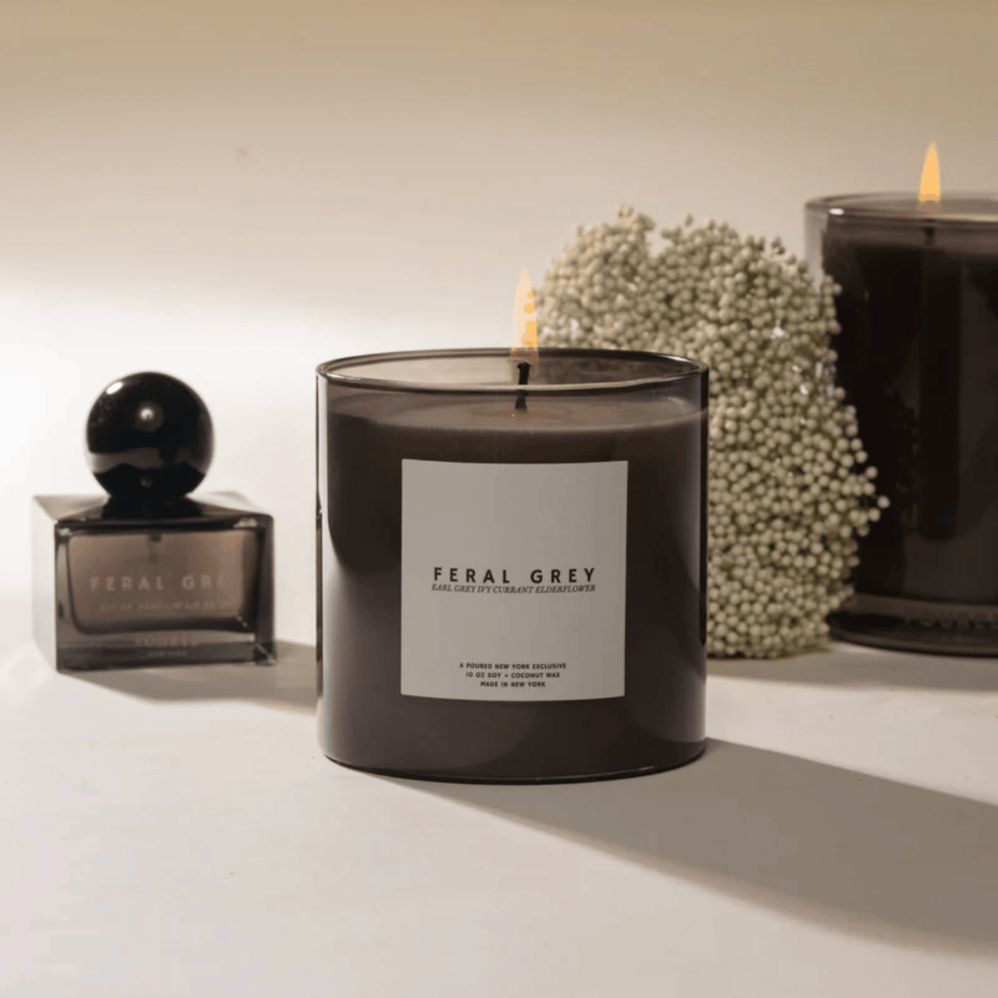 Alternate Image of Feral Grey Candle, dark grey vessel with white label and square gray perfume bottle