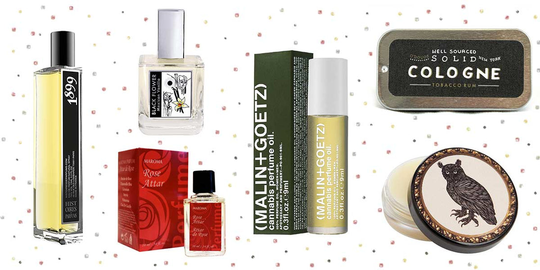 Assortment of niche fragrance products including perfumes, oils, cologne, and balm on a confetti background