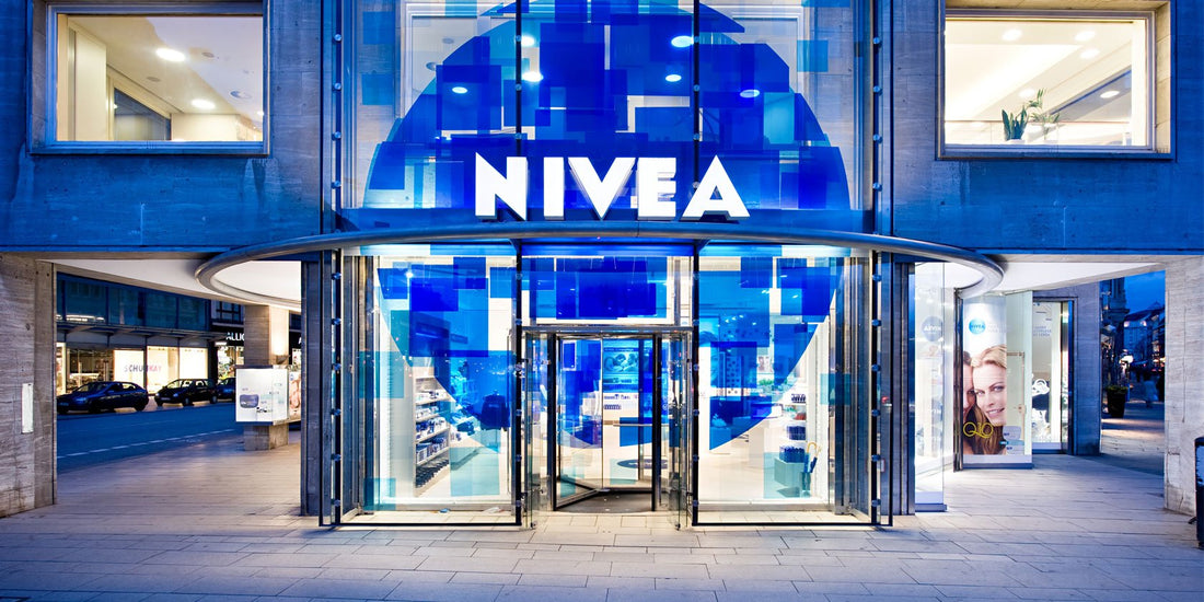 NIVEA storefront entrance with blue glass facade and illuminated NIVEA sign