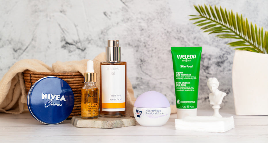 Five German beauty products displayed on a shelf with a plant and decorative objects
