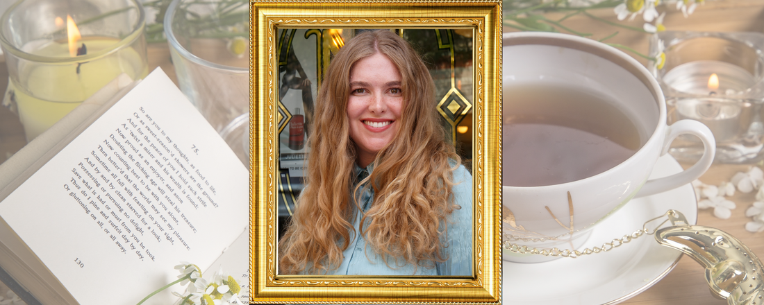 Portrait of Hannah Black in an ornate gold frame with a teacup, open book, and candles