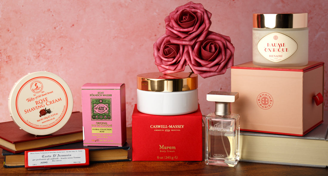 Valentine’s Day gift arrangement featuring rose shaving cream, cologne, body cream, perfume, candle, and red roses