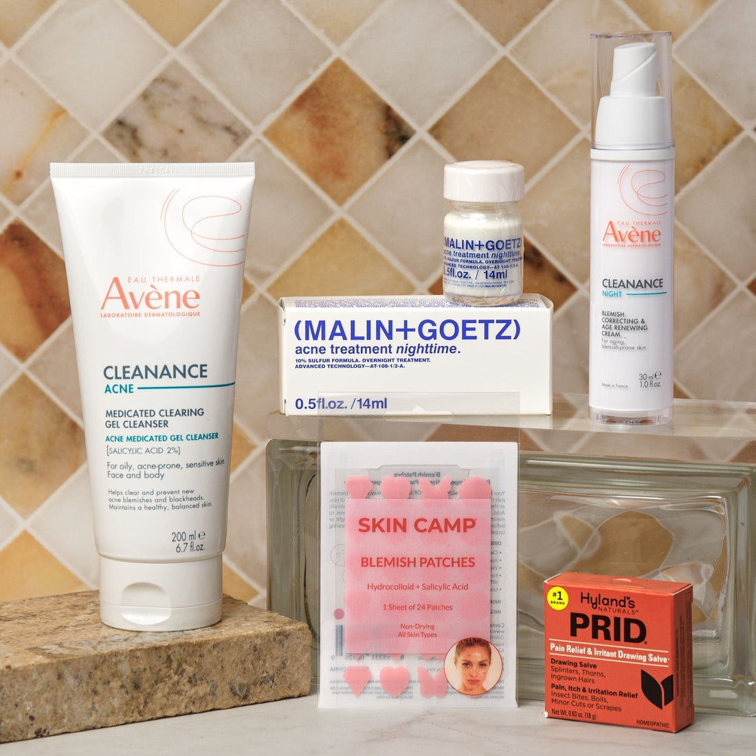 Acne treatment products including Avène cleanser, Malin Goetz treatment, Skin Camp blemish patches, and PRID salve