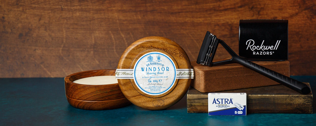 Shaving tools and soap arranged on wooden blocks for a sustainable grooming routine