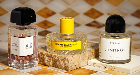 Three niche fragrance bottles, BDK Bouquet de Hongrie, Vilhelm Moon Carnival, and Byredo Velvet Haze, on tile