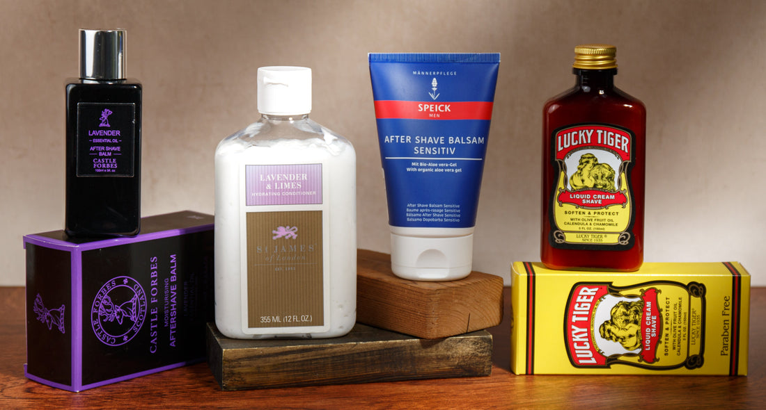 Assortment of men’s grooming products including after-shave balms, conditioner, and shaving cream arranged on wooden blocks
