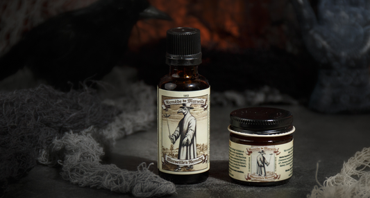 Marseille’s Remedy essential oil blend bottle and jar displayed in a spooky, smoke-filled setting