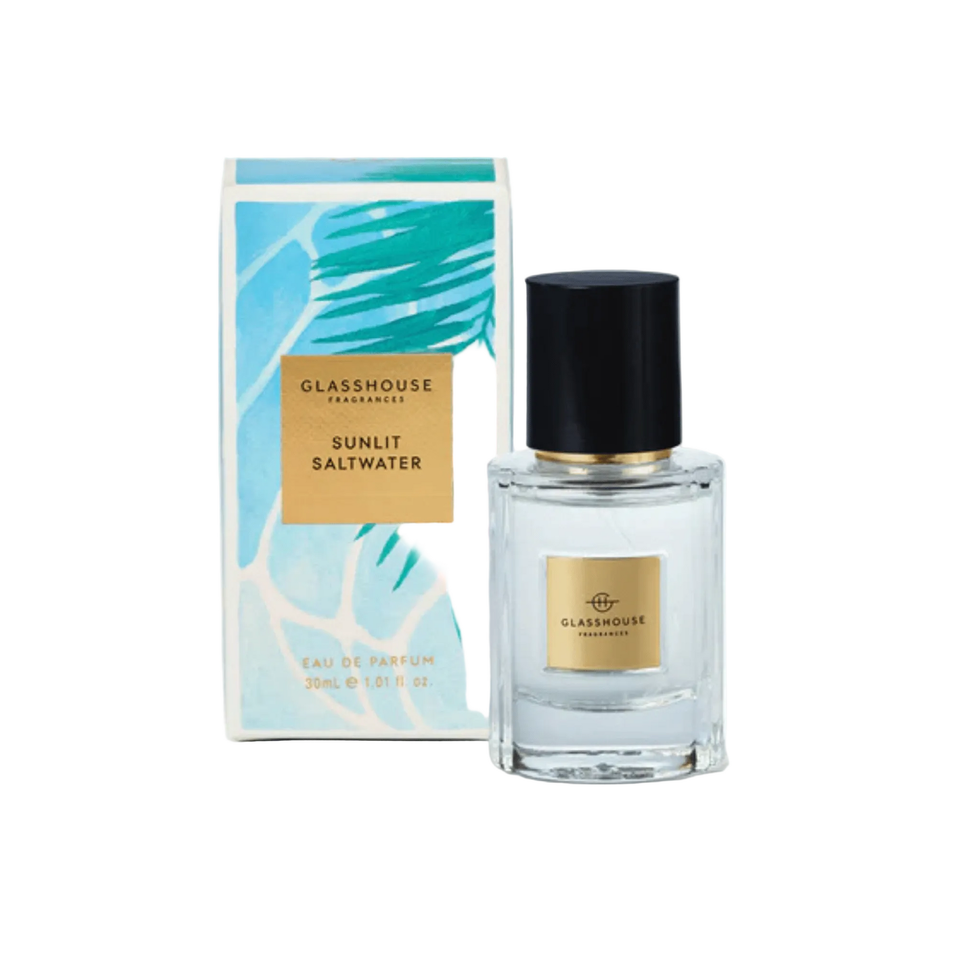 Primary image of GlassHouse Sunlit Saltwater EDP front of perfume with packaging to the left of the bottle 