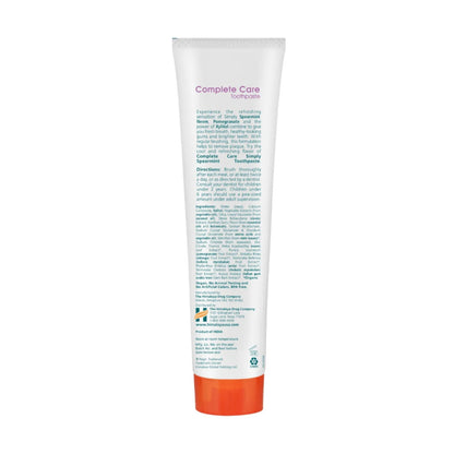 Back view of Complete Care Simply Spearmint Toothpaste tube showing white packaging and an orange cap on a white background