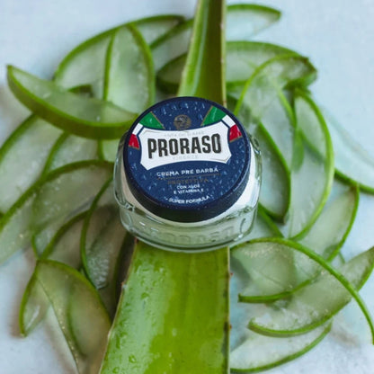 Top view of Proraso Protect Pre-Shave Cream showcasing its round jar on aloe vera leaves