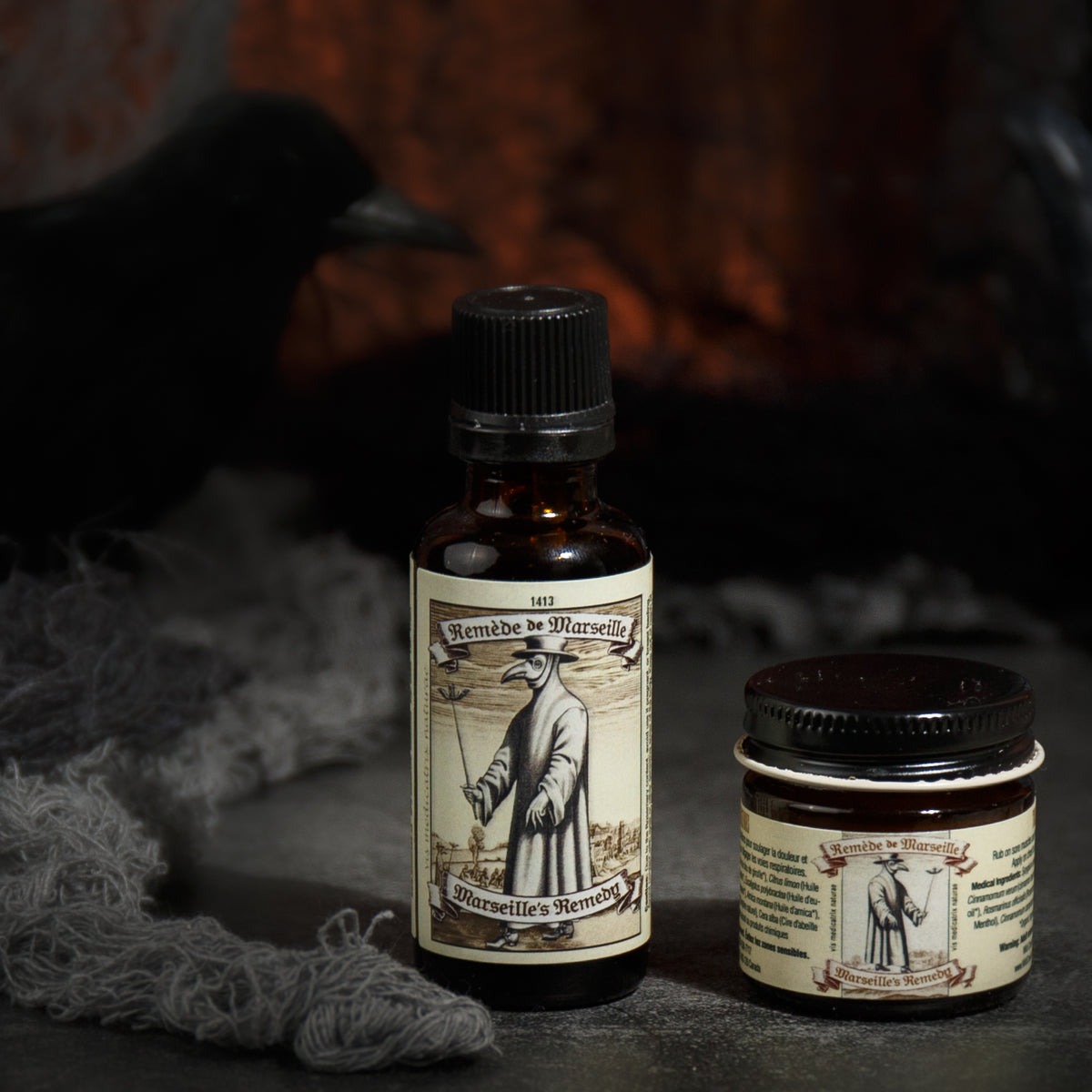 Front view of Marseille’s Remedy Traditional Oil showcasing its illustrated label in a dark, smoky setting