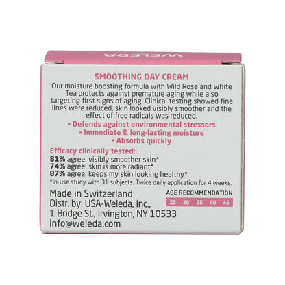 Back view of Weleda Smoothing Day Cream box showcasing wild rose, white tea, and moisture claims on a white background