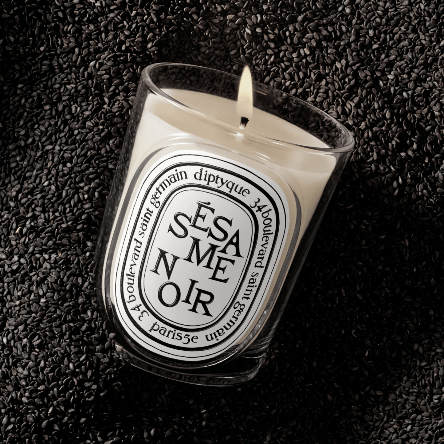 Alternate Image of Sesame Noir Candle, clear glass vessel with black and white oval label