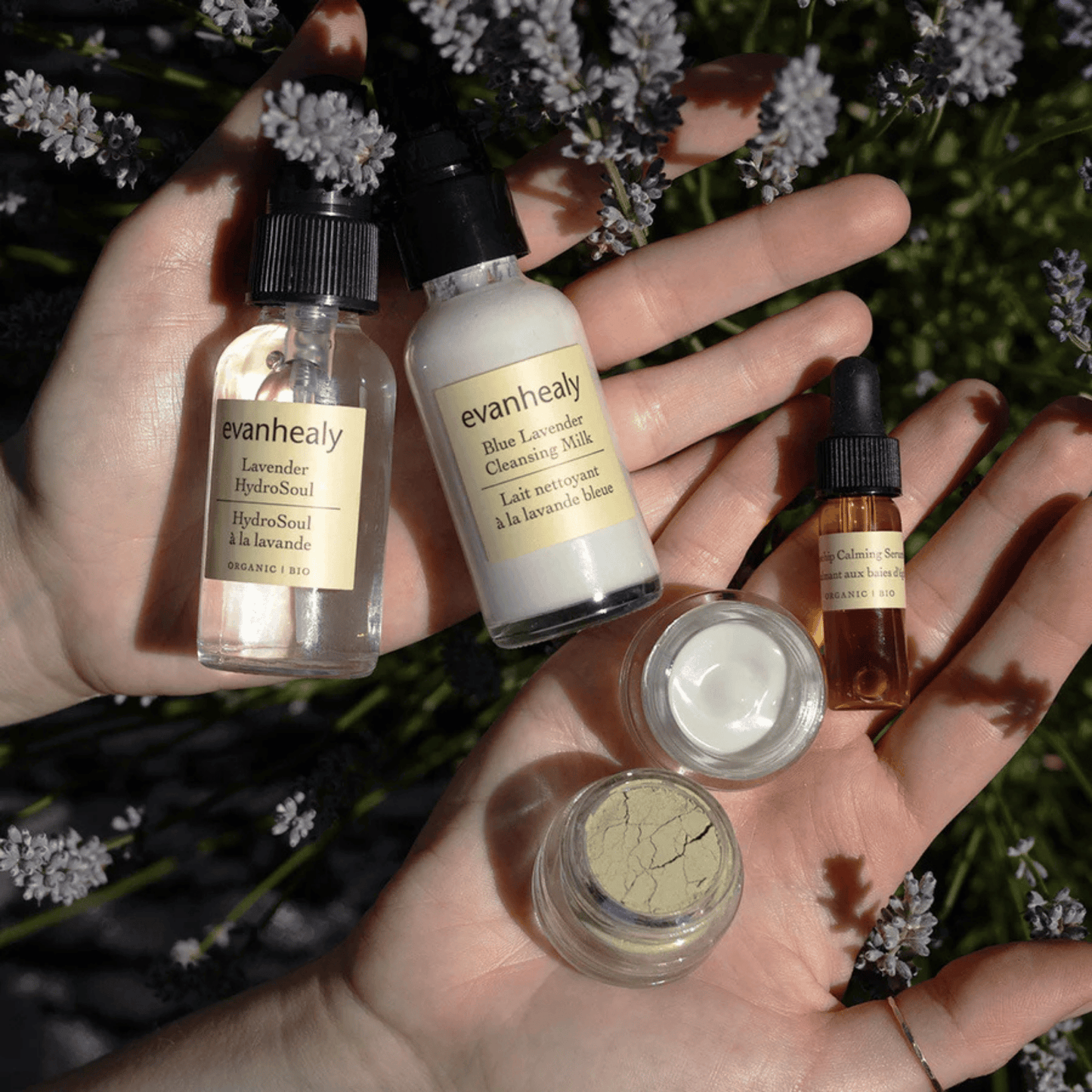 Overhead view of the Calming Ritual Face Care Kit showcasing five skincare products with flowers in the background