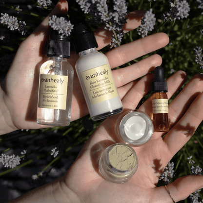 Overhead view of the Calming Ritual Face Care Kit showcasing five skincare products with flowers in the background