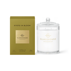 Front view of Kyoto In Bloom Candle showcasing a white glass jar and gold box on a white background
