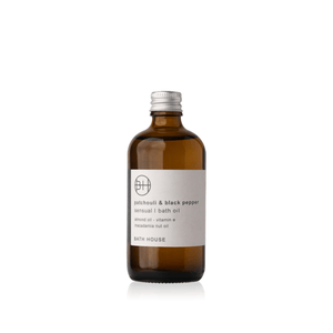 Front view of Patchouli & Black Pepper Bath Oil showcasing its amber bottle and white label on a white background