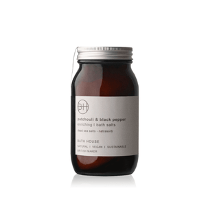 Front view of Bath House Patchouli and Black Pepper Bath Salts in an amber jar with a silver lid on a white background