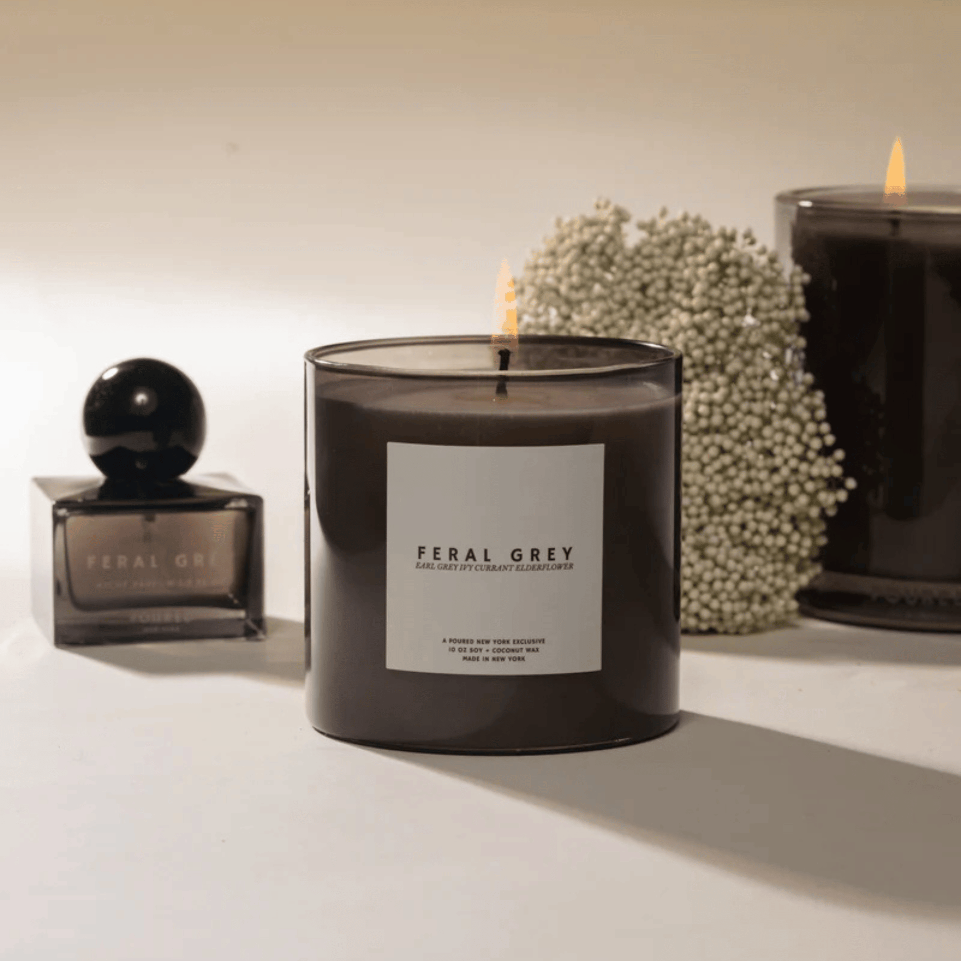 Alternate Image of Feral Grey Candle, dark grey vessel with white label and square gray perfume bottle