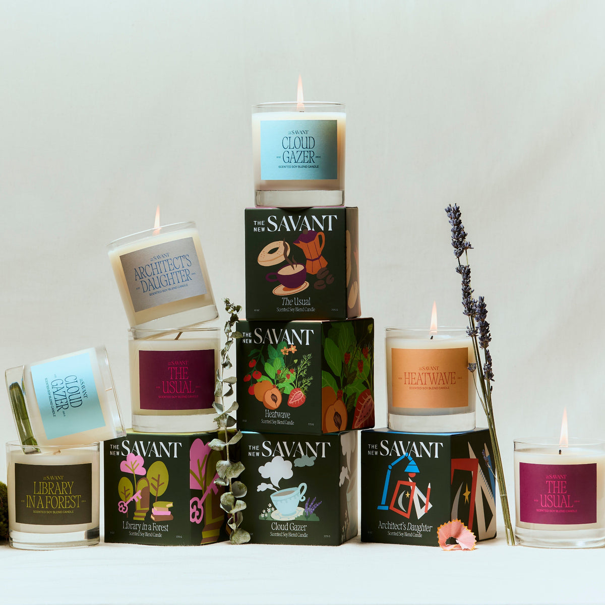 Alternate Image of The New Savant Candles, group shot of candles and boxes with colorful labels 