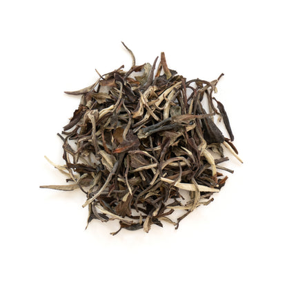 Top view of Fancy White Peony Tea Organic showcasing loose tea leaves on a white background