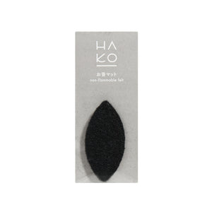 Front view of HA KO Paper Incense Burner Mat showcasing its black knitted felt surface in gray packaging